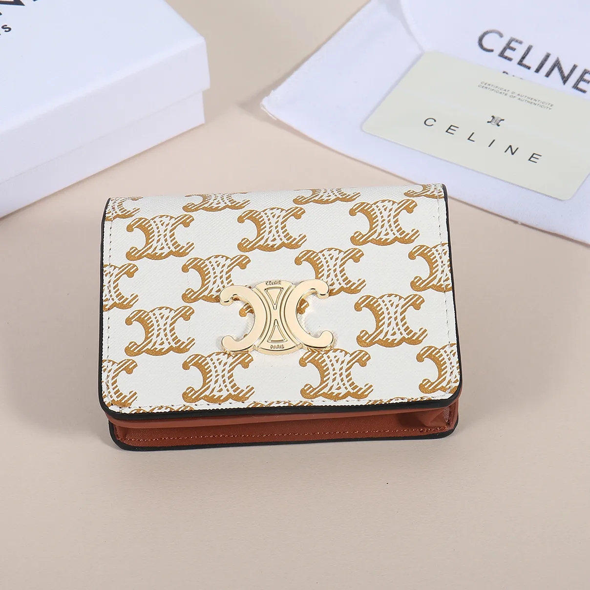 60. Celine classic card holder, TRIOMPHE business card holder, large cowhide interior with plain microfiber TRIOMPHE CANVAS logo print, gold finish TRIOMPHE metal snap closure, 1 zipper coin pocket, 5 card slots, 1 banknote pocket, 1 flat pocket No.: 10K623 Size: 11 X 9 X 3 cm