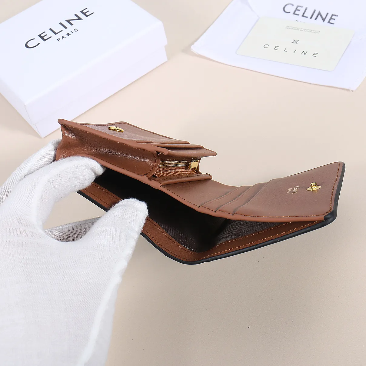 60. Celine classic card holder, TRIOMPHE business card holder, large cowhide interior with plain microfiber TRIOMPHE CANVAS logo print, gold finish TRIOMPHE metal snap closure, 1 zipper coin pocket, 5 card slots, 1 banknote pocket, 1 flat pocket No.: 10K623 Size: 11 X 9 X 3 cm