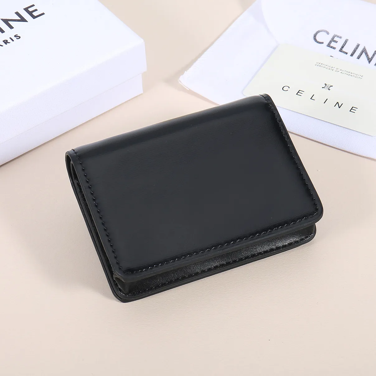 60. Celine classic card holder, TRIOMPHE business card holder, large cowhide interior with plain microfiber TRIOMPHE CANVAS logo print, gold finish TRIOMPHE metal snap closure, 1 zipper coin pocket, 5 card slots, 1 banknote pocket, 1 flat pocket No.: 10K623 Size: 11 X 9 X 3 cm