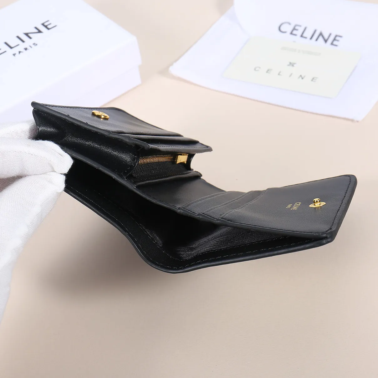 60. Celine classic card holder, TRIOMPHE business card holder, large cowhide interior with plain microfiber TRIOMPHE CANVAS logo print, gold finish TRIOMPHE metal snap closure, 1 zipper coin pocket, 5 card slots, 1 banknote pocket, 1 flat pocket No.: 10K623 Size: 11 X 9 X 3 cm