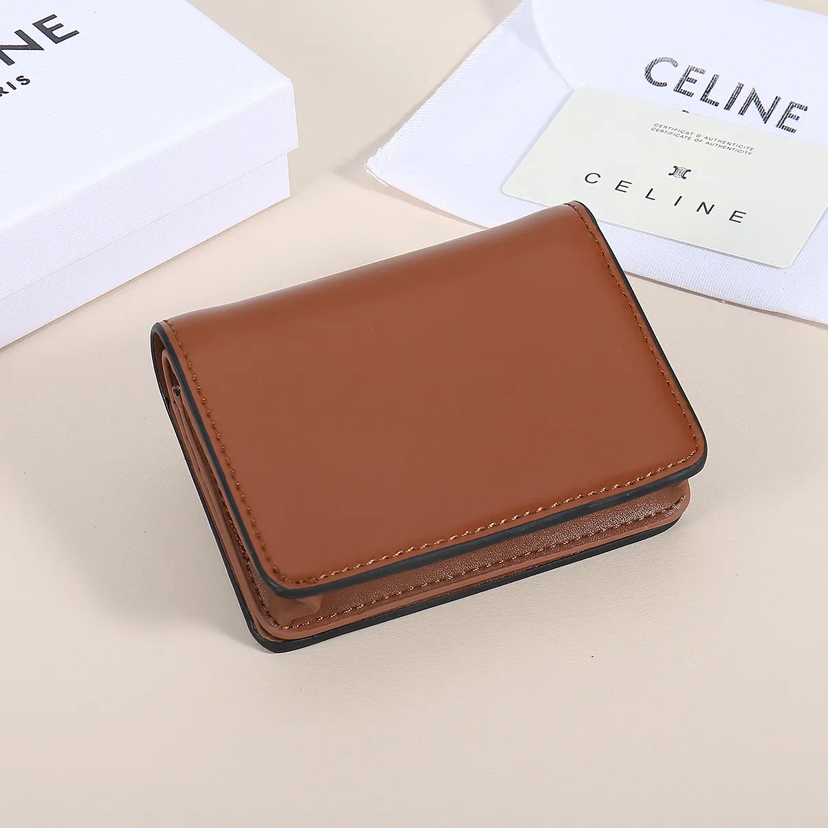 60. Celine classic card holder, TRIOMPHE business card holder, large cowhide interior with plain microfiber TRIOMPHE CANVAS logo print, gold finish TRIOMPHE metal snap closure, 1 zipper coin pocket, 5 card slots, 1 banknote pocket, 1 flat pocket No.: 10K623 Size: 11 X 9 X 3 cm