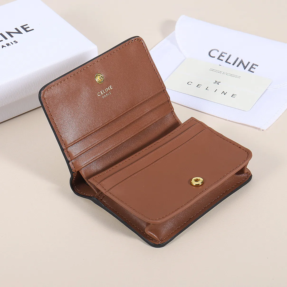 60. Celine classic card holder, TRIOMPHE business card holder, large cowhide interior with plain microfiber TRIOMPHE CANVAS logo print, gold finish TRIOMPHE metal snap closure, 1 zipper coin pocket, 5 card slots, 1 banknote pocket, 1 flat pocket No.: 10K623 Size: 11 X 9 X 3 cm