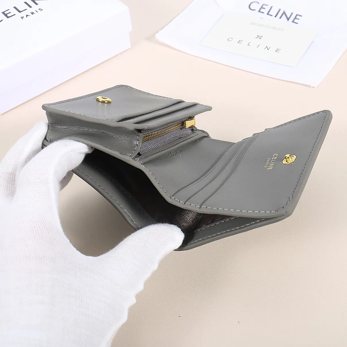60. Celine classic card holder, TRIOMPHE business card holder, large cowhide interior with plain microfiber TRIOMPHE CANVAS logo print, gold finish TRIOMPHE metal snap closure, 1 zipper coin pocket, 5 card slots, 1 banknote pocket, 1 flat pocket No.: 10K623 Size: 11 X 9 X 3 cm