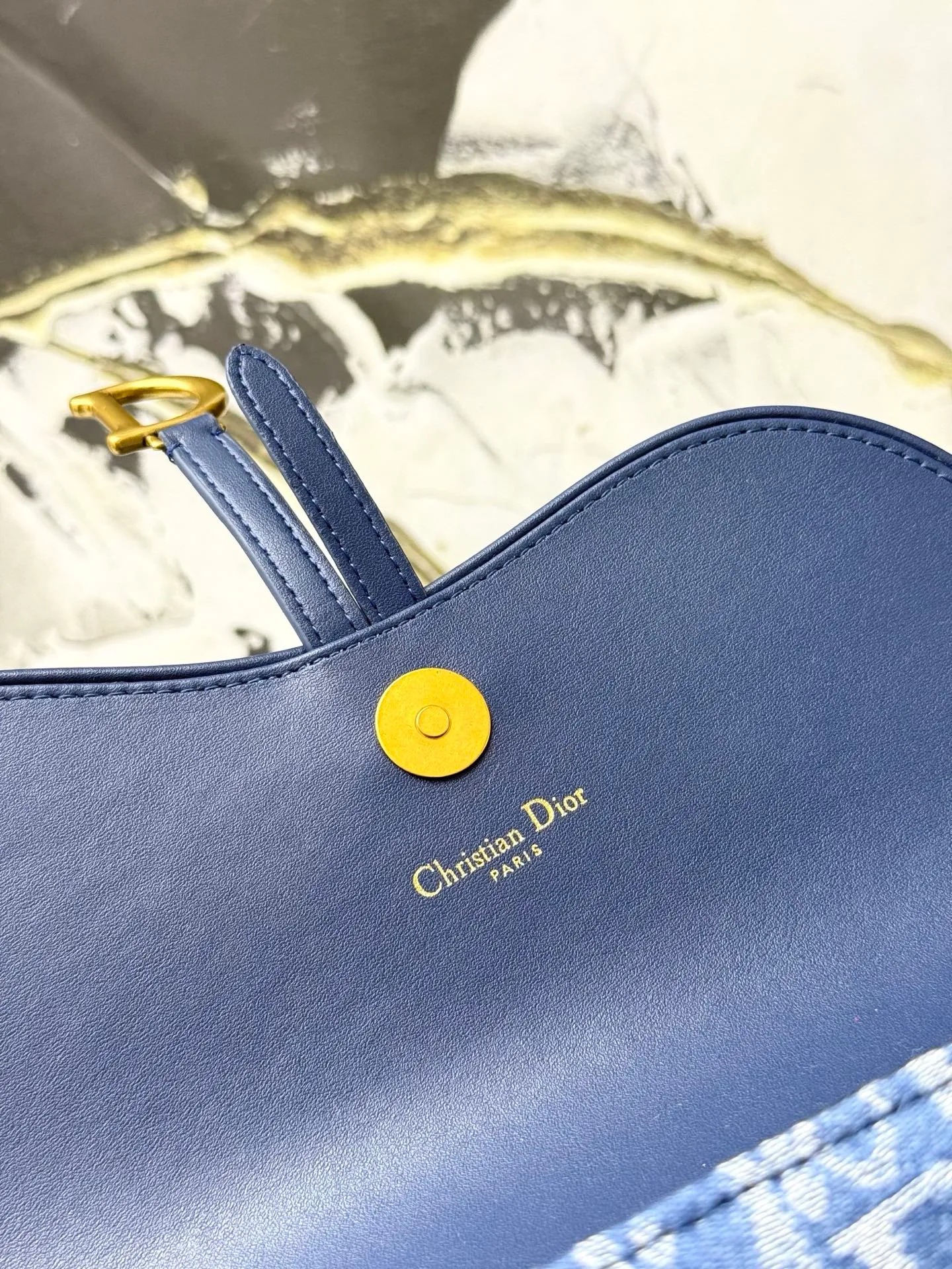 💰290💰 This saddle chain handbag has smooth and coordinated lines, making it a fashionable and practical item. Carefully crafted from blue Denim Dior Oblique jacquard fabric, the classic Dior pattern is reinterpreted with an irregular stonewash effect to highlight the fashionable style. It is paired with an asymmetric flap and a metal stirrup D-shaped pendant with antique gold finish. The spacious interior compartments can store a variety of daily essentials, and the chain makes it easy to carry on the shoulder or cross-body. Easily combines with other pieces from the saddle collection. Flap closure No.: S5907CTZQ_M928 Front stirrup D-shaped charm 1 compartment 6 card slots 1 slip pocket - No.: S5097 Dimensions: 21.5x12.5x3.7 cm (LxHxW) Can store 1 mobile phone, 1 card holder and lipstick Chain length: 118 cm Length from the top of the chain to the top of the bag: 57 cm