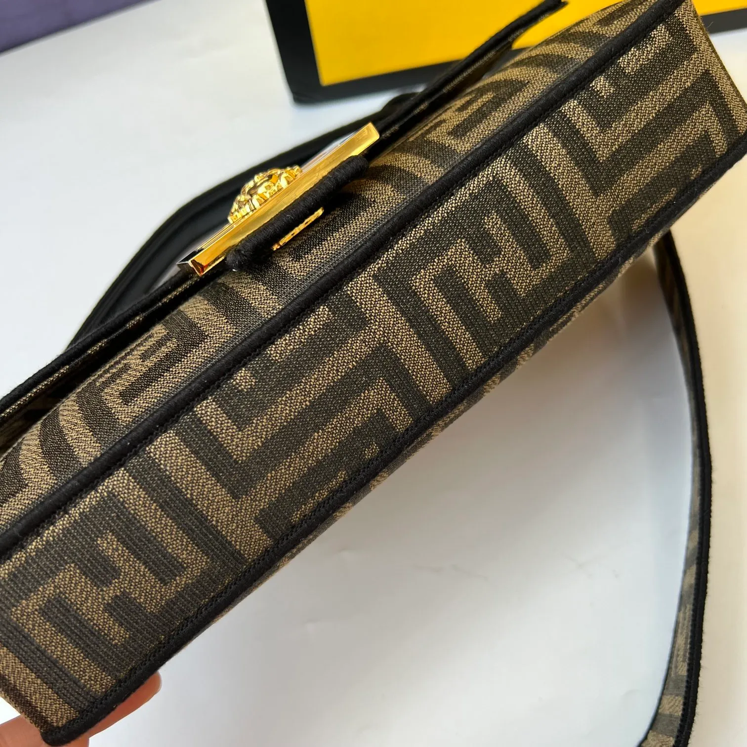 All Categories Official Website "Brand Women's Bags" Women's Bags 💙 FENDI The latest FendiVersace co-branded model, the iconic Baguette medium handbag adopts a clamshell design and is equipped with FF magnetic buckle closure. Lined interior with zip pocket. Comes with a detachable handle or shoulder strap for cross-body or hand carry. Decorated with tonal FF logo embroidery. Contrasting brown leather trim