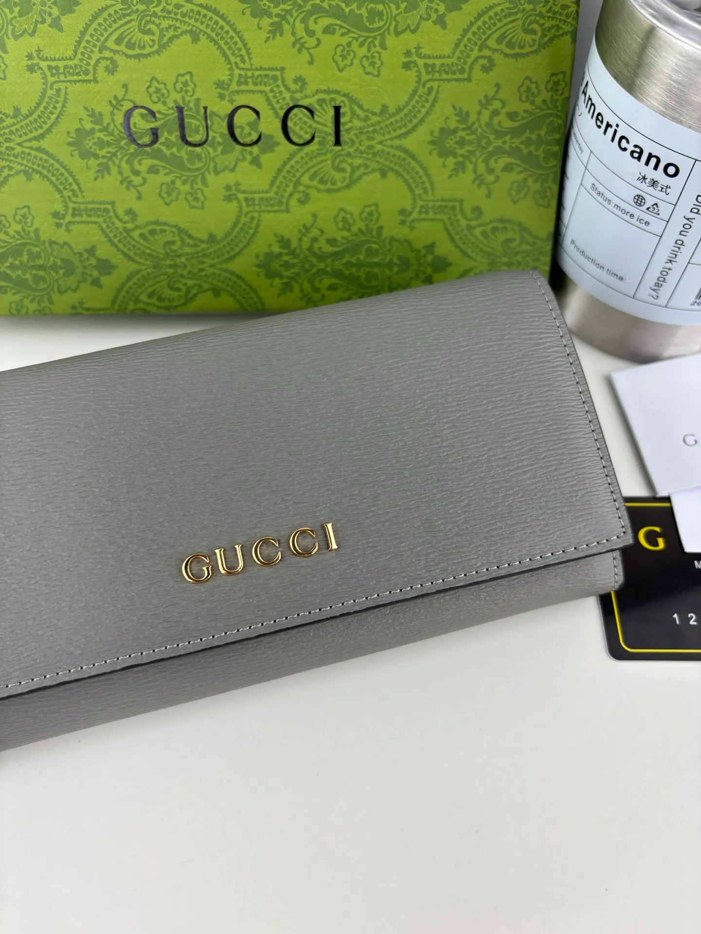 💰170 GUCCl long clip wallet with handwritten Gucci logo. Exploring self-expression with unlimited possibilities has become the spiritual connotation of brand design. Crafted from gray leather, this long clip is embellished with a gold-toned handwritten Gucci logo-shaped hardware, adding a touch of the brand's signature charm to the entire design. Gray leather, gold-tone hardware, taffeta lining, script Gucci logo detail. INTERIOR: Twelve card compartments, two bill compartments, two separate internal compartments and a zipped coin pocket, this classic piece features snap closure Style number: 772638 Dimensions: 19cm x 10cm x 3.5cm Colour: Gray