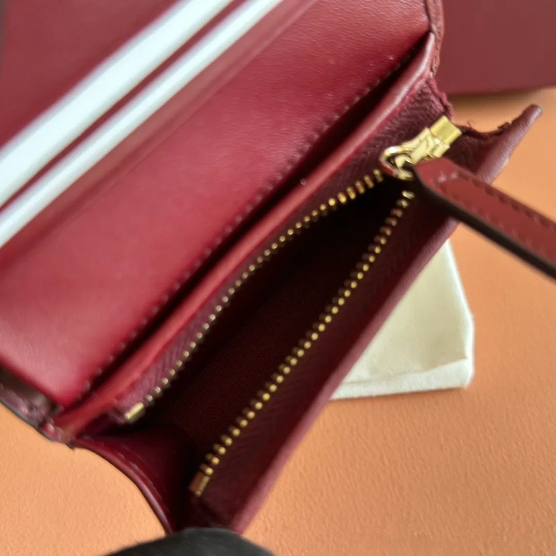 p420. 💋💋💋"With full set of original counter packaging"💕2025 autumn and winter series, GG Emblem series reinterprets the brand's timeless elegance and exquisite craftsmanship. This small wallet features five card compartments, an open pocket, a zip pocket and a bill compartment for added functionality. Gucci Rosso Ancora GG printed embossed cow leather Gold tone accessories The handbag pictured is sold separately and does not come with the bag charms. Five card compartments, one open pocket, one zip pocket and one bill compartment Button closure Ident No.: 847207. Dimensions when closed: 11cm (W) x 8.5cm (H) x 3cm (D); Dimensions when open: 11cm (W) x 17.5cm (H) Weight: approx. 0.13kg Color: Embossed Anchor Red. Made in Italy