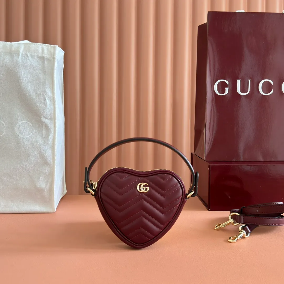 p940. 💋💋💋"With full set of original counter packaging" [New product] This GG Marmont series mini handbag has a playful and cute heart-shaped silhouette and is crafted from soft Gucci Ancola red V-shaped Matelassé cow leather. The bag has a simple and compact shape and is equipped with the iconic Double G accessories in light gold tones. Gucci Rosso Ancora red quilted V-shaped calfskin leather Light gold tone hardware Red taffeta lining Double G Interior: One card compartment Carry handle (8 cm height) Detachable and adjustable shoulder strap (48 cm height) Zip closure Weight: approx. 0.162 kg Ident number: 837753. Dimensions: 13.5cm (width) x 11.5cm (height) x 2.5cm (depth) Color: Red full leather. Made in Italy