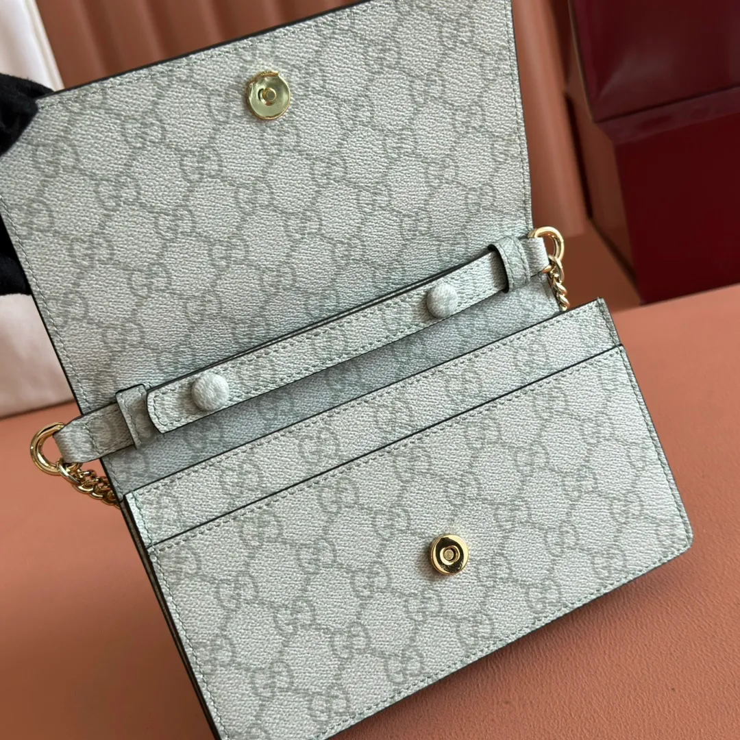 p640. Equipped with a full set of packaging at the counter [New Product] The GG Emblem series reinterprets the brand's timeless elegance and exquisite craftsmanship. This sage-green chain wallet is crafted from leather and GG monogram coated fabric and features a chain strap. Grey-green glossy leather Grey-green GG Supreme canvas Gucci print embossed details Taffeta lining Interior: 6 card compartments, 2 flat pockets, 1 zipped pocket Chain shoulder strap (52 cm high) Ident.: 826720. Dimensions: 20 cm (width) x 13 cm (height) x 4 cm (depth) Weight: about 413 grams Color: green gray pvc/original leather. Made in Italy