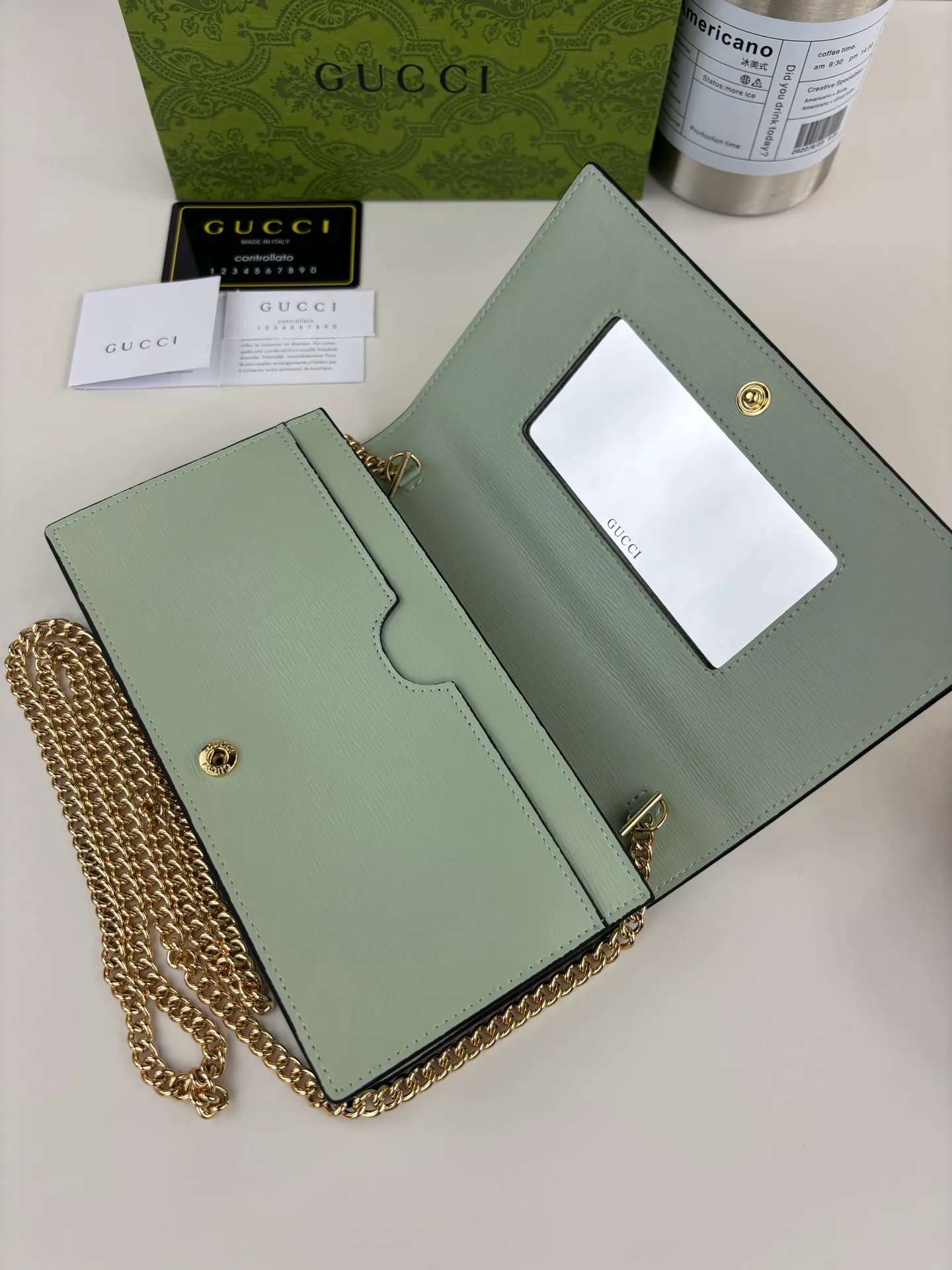💰230 GUCCl chain wallet with handwritten Gucci logo. The small leather accessories series seamlessly integrates modern fashion elements to create ingenious items with changing styles without losing classic connotation, bringing fresh vitality to formal leather items. This chain wallet is crafted from green leather and features the Gucci logo in gold-tone script. Green leather, gold-tone hardware, taffeta lining, scripted Gucci logo detail, interior: six card compartments, one flat pocket, one zipped gusset pocket and one open compartment, chain strap, snap button closure. Style number: 772643 Size: 20cm x 12.5cm x 4cm Color: Green