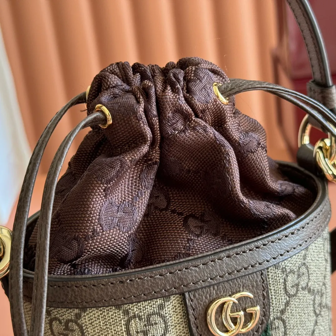 p1000💋💋💋"With full set of original counter packaging" [New Product] The Ophidia series ingeniously interprets novel silhouettes and functions, with iconic beige and brown colors, creating a bag with soft texture and fashionable style. This bucket bag features a top handle and a shoulder strap. Beige and dark brown GG monogram coated fabric Gucci Rosso Ancora leather trim Light gold tone hardware Gucci Ancora taffeta lining and green cotton linen lining Double G webbing handles (12 cm high) removable and adjustable leather shoulder strap (52 cm high) drawstring fly Ident: 838462. Dimensions: 11.5cm (width) x 23cm (height) x 8cm (depth) Weight: approx. 312g Color: brown/PVC. Made in Italy