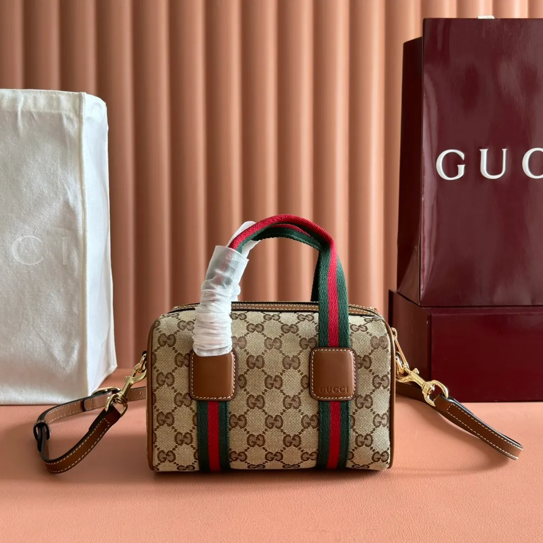 p960💋💋💋. "With full set of original counter packaging" [New Product] Inspired by Gucci's iconic travel bag silhouette, the brand launched the Mini GG handbag. This handbag is crafted from soft GG presbyopic canvas and is equipped with web handles and a detachable shoulder strap. It reinterprets the brand's classic elements and pays homage to Gucci's proud travel tradition. Beige and dark brown GG monogram coated fabric Ankara red leather trim Light gold tone hardware Green linen cotton blend lining Carry handles (10cm high) Detachable and adjustable leather shoulder strap (50cm high; Length: 101.5cm) Model number: 859975. Dimensions: 20cm (W) x 13cm (H) x 13cm (D) Weight: approx. 0.4kg Colour: Brown cloth/PVC. Made in Italy