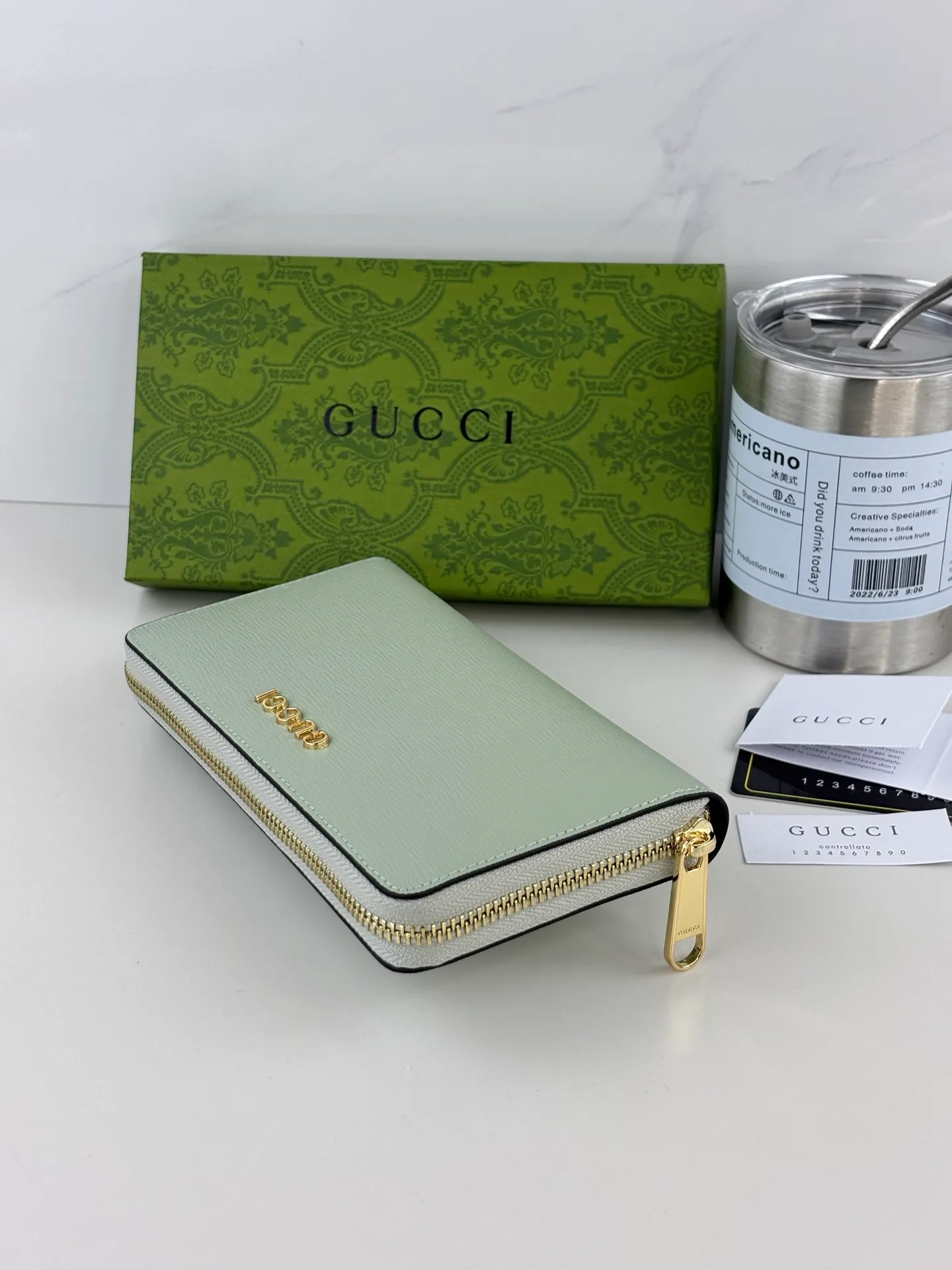 💰170 GUCCl Long zipper wallet with handwritten Gucci logo. Exploring self-expression with unlimited possibilities has become the spiritual connotation of brand design. Crafted from green leather, this long clip is embellished with a gold-toned handwritten Gucci logo-shaped hardware, adding a touch of the brand's signature charm to the entire design. Green leather, gold-tone hardware, taffeta lining, scripted Gucci logo detail. Interior: Six card compartments, two bill compartments, two separate internal compartments and a zippered coin pocket, this classic piece features a zipper closure Style number: 772642 Dimensions: 19cm x 10cm x 3.5cm Colour: Green