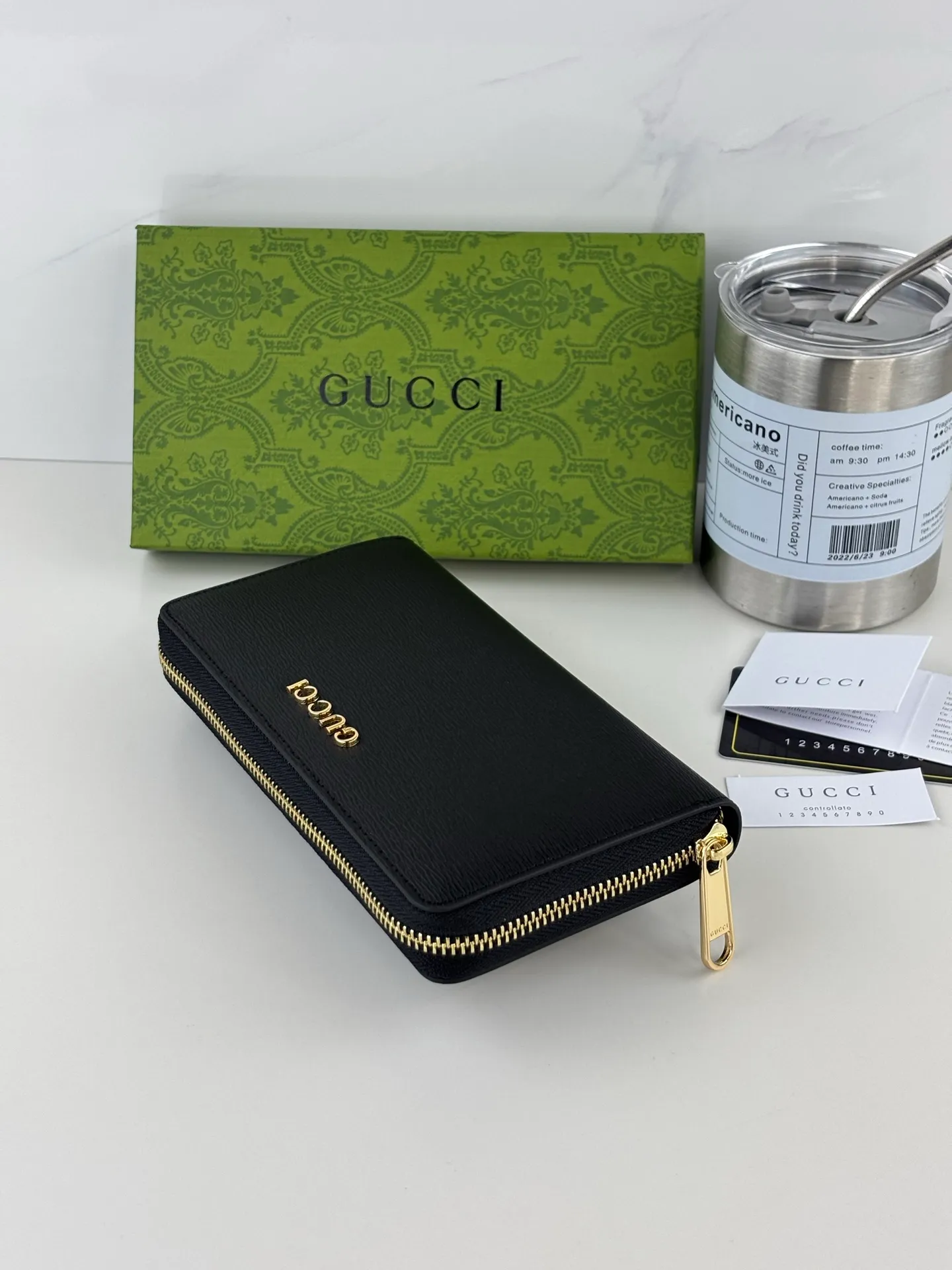 💰170 GUCCl Long zipper wallet with handwritten Gucci logo. Exploring self-expression with unlimited possibilities has become the spiritual connotation of brand design. Crafted from black leather, this long clip is embellished with a gold-toned handwritten Gucci logo-shaped hardware, adding a touch of the brand's signature charm to the entire design. Black leather, gold-tone hardware, taffeta lining, script Gucci logo detail. Interior: Six card compartments, two bill compartments, two separate internal compartments and a zippered coin pocket, this classic piece features a zipper closure Style number: 772642 Dimensions: 19cm x 10cm x 3.5cm Colour: Black