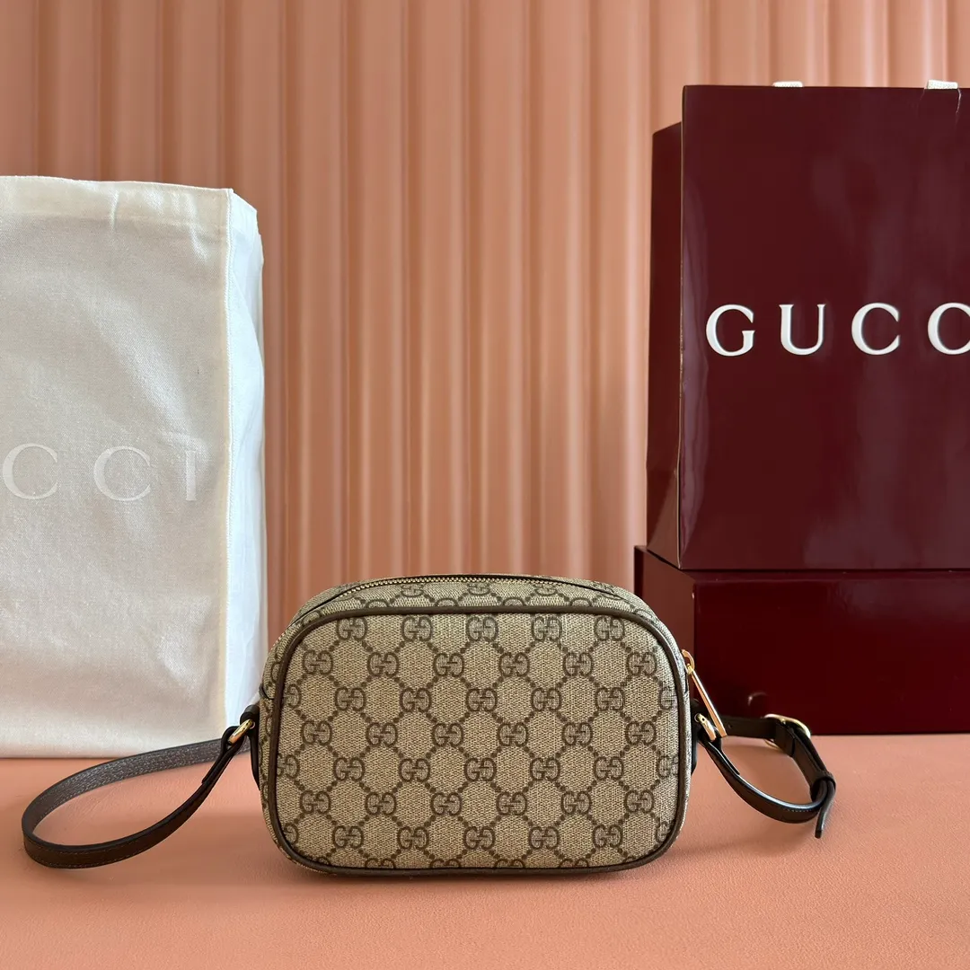 p960. 💋💋💋"With full set of original counter packaging" [New Product] Inspired by Gucci's iconic travel bag silhouette, the brand launched the Mini GG handbag. This handbag is crafted from soft GG presbyopic canvas and is equipped with web handles and a detachable shoulder strap. It reinterprets the brand's classic elements and pays homage to Gucci's proud travel tradition. Beige and dark brown GG monogram coated fabric Dark brown leather piping Light gold tone hardware Green linen cotton blend lining Carry handles (10cm high) Removable and adjustable leather shoulder strap (50cm high; Length: 101.5cm) Model: 859975. Dimensions: 20cm (W) x 13cm (H) x 13cm (D) Weight: approx. 0.4kg Colour: Brown/PVC. Made in Italy