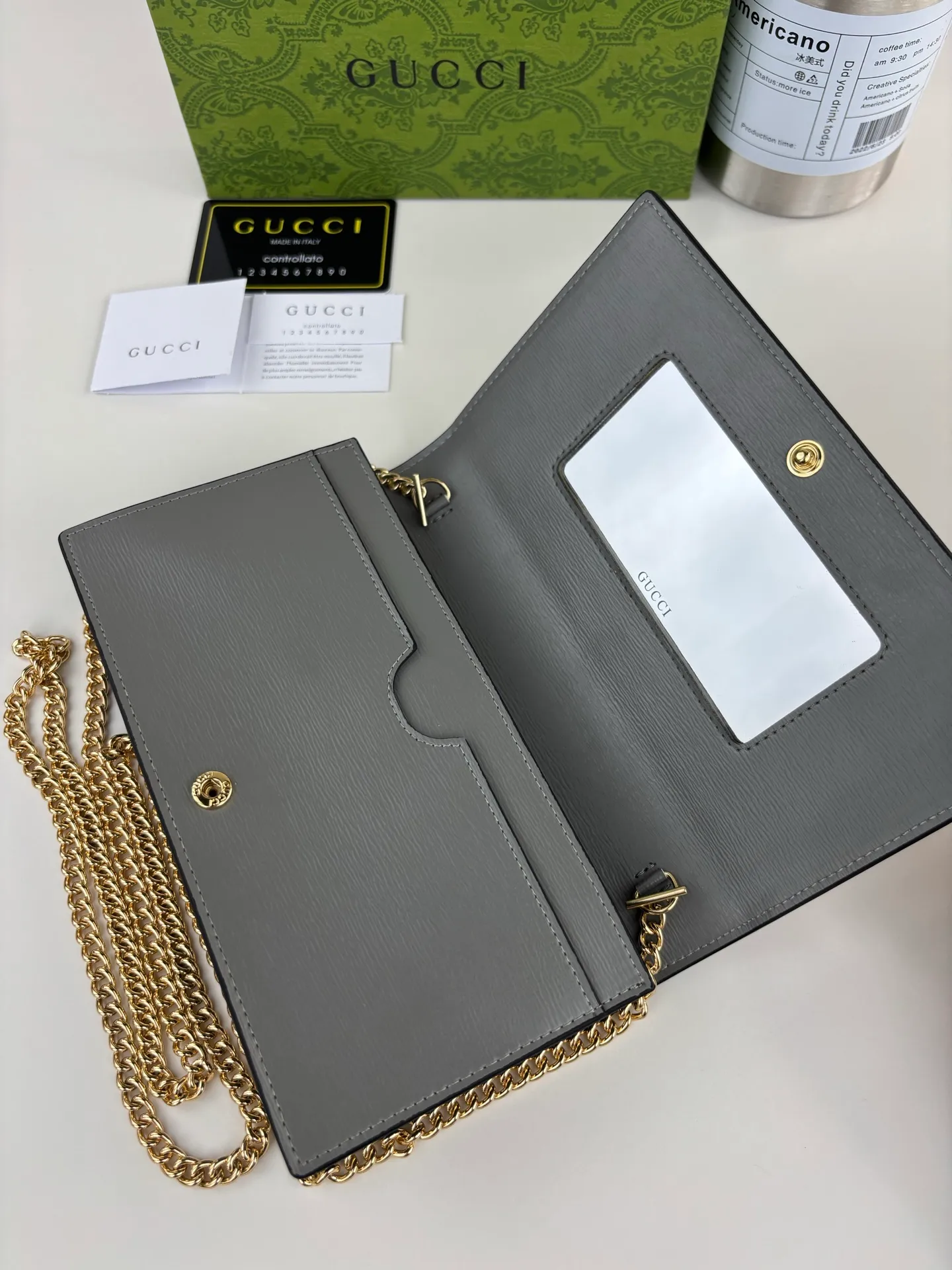 💰230 GUCCl chain wallet with handwritten Gucci logo. The small leather accessories series seamlessly integrates modern fashion elements to create ingenious items with changing styles without losing classic connotation, bringing fresh vitality to formal leather items. This chain wallet is crafted from gray leather and features the Gucci logo in gold-tone script. Gray leather, gold-tone hardware, taffeta lining, scripted Gucci logo detail, interior: six card compartments, one flat pocket, one zipped gusset pocket and one open compartment, chain strap, snap-stud fastening. Style number: 772643 Size: 20cm x 12.5cm x 4cm Color: Gray