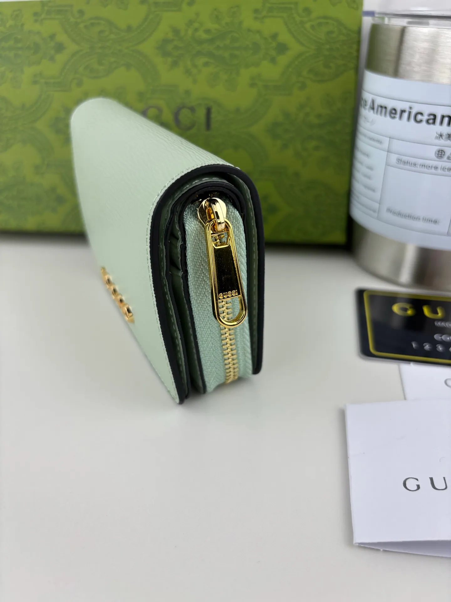 💰160 GUCCl chain wallet with handwritten Gucci logo. The small leather accessories series seamlessly integrates modern fashion elements to create ingenious items with changing styles without losing classic connotation, bringing fresh vitality to formal leather items. This chain wallet is crafted from green leather and features the Gucci logo in gold-tone script. Green leather, gold-tone hardware, taffeta lining, scripted Gucci logo detail, interior: six card compartments, one zipped gusset pocket and one open compartment, chain strap, snap button fastening. Style number: 772639 Size: 9cmx 11cmx 2.5cm Color: Green