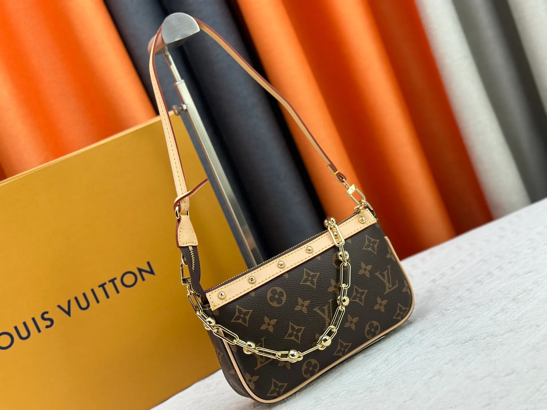 P220 M13404 M13663 Black color White color This Pochette Accessoires handbag is made of coated canvas, with colorful Monogram patterns to interpret the smart style of the Louis Vuitton × Murakami cross-border collaboration series. Calf leather trim and dazzling hardware add to the sophisticated details, while the detachable shoulder strap and chain provide flexible carry. Size: 22x13x4cm