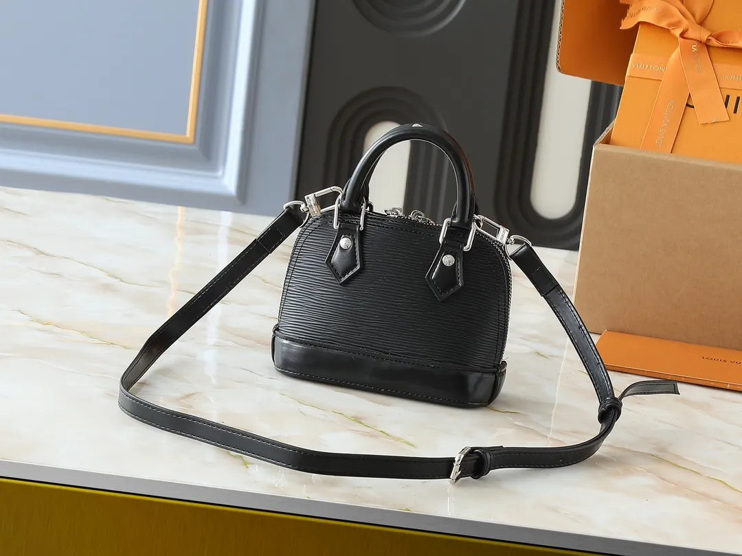 💰220💰Upgraded original M81945 M82411 M82717 This Nano Alma handbag is a pocket-sized version of Louis Vuitton's classic Alma handbag, this time made of iconic Epi grain leather. The compact design has ample space to easily store smartphones, keys, card holders, travel fragrances and other travel essentials. The handles and removable and adjustable shoulder strap allow for a variety of carrying options. Dimensions: 18 x 12 x 8 cm (length x height x width)