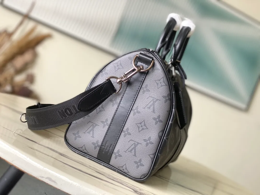 💰960 Top Original M46655 Black Flower Keepall Bandoulière 35 Handbag is a miniature version of the classic Keepall holiday travel bag. Full-grain Taurillon leather embossed with the Monogram pattern, leather side straps and top leather handle continue the signature elements of the Keepall collection, and the shoulder strap is removable and adjustable. Dimensions: 34 x 21 x 16 cm