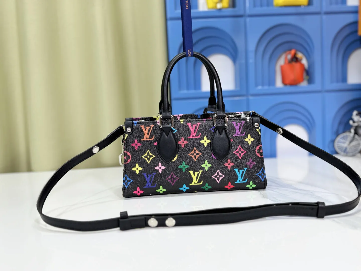 P300 Upgraded Original M13260 M46653 Takashi Murakami Collaboration Black Color White Color This OnTheGo East West handbag is made of cow leather to create a slender shape, and the Monogram flower nameplate completes the elegant style. Articulated handles and a detachable leather chain strap allow for a variety of carrying options. Size: 25x13x10cm
