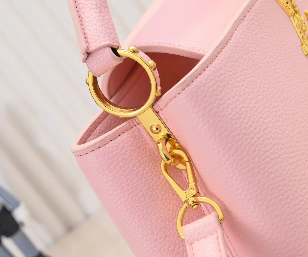 Upgraded version P440 M24664 This medium-sized CapucinesEastWest handbag is from the LVCrush series, with eye-catching forged LV letters lighting up the grained cow leather body. The rolled leather top handle allows for hand or elbow carry, and the adjustable and removable spaghetti strap makes it easy to carry over the shoulder. Personalized Gift Detailed Features 33 x 19 x 9 cm (Length x Height x Width)