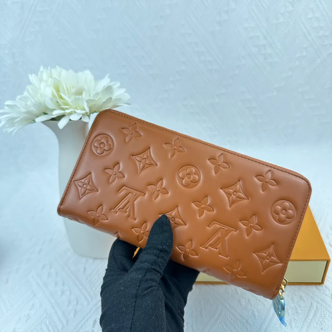P130 M81511 Earthy Yellow Sewn with padded Monogram embossed lambskin, it complements the Coussin leather boutique series. Beautifully designed with a gold-tone zipper embossed with the LV Circle signature pull, the interior of the all-in-one wallet is packed with practical features, including three large compartments, a coin compartment and 12 business card slots. Dimensions: 19.5 x 10.5 x 2.5 cm