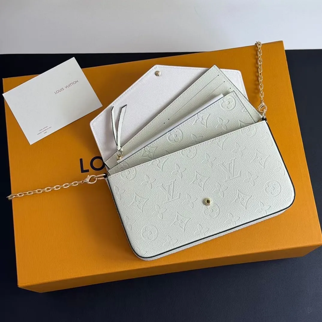 P150💰💖This Pochette Félicie three-in-one💖 chain bag is made of Monogram Empreinte leather, with subtle embossing to present Louis Vuitton’s classic Monogram pattern. The envelope-style construction offers ample interior space, and includes a removable zippered pocket and card compartment. Attach the chain to explore more modern carrying options. Model: M64065 white / 61276 Dimensions: 21 x 12 x 3 cm (length x height x width)
