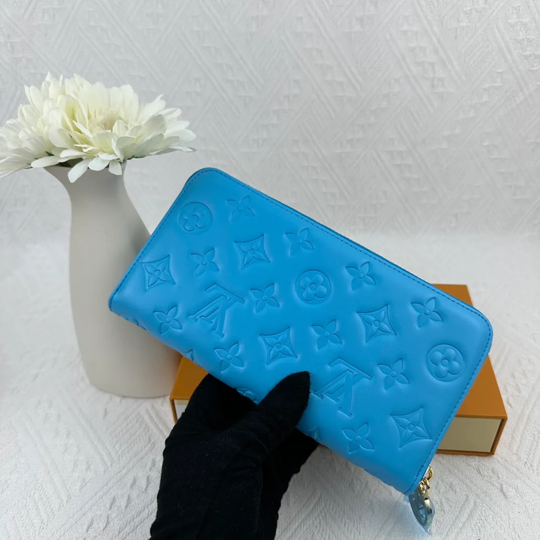 P130 M81511 blue Stitched with padded Monogram embossed lambskin, it complements the Coussin leather boutique collection. Beautifully designed with a gold-tone zipper embossed with the LV Circle signature pull, the interior of the all-in-one wallet is packed with practical features, including three large compartments, a coin compartment and 12 business card slots. Dimensions: 19.5 x 10.5 x 2.5 cm
