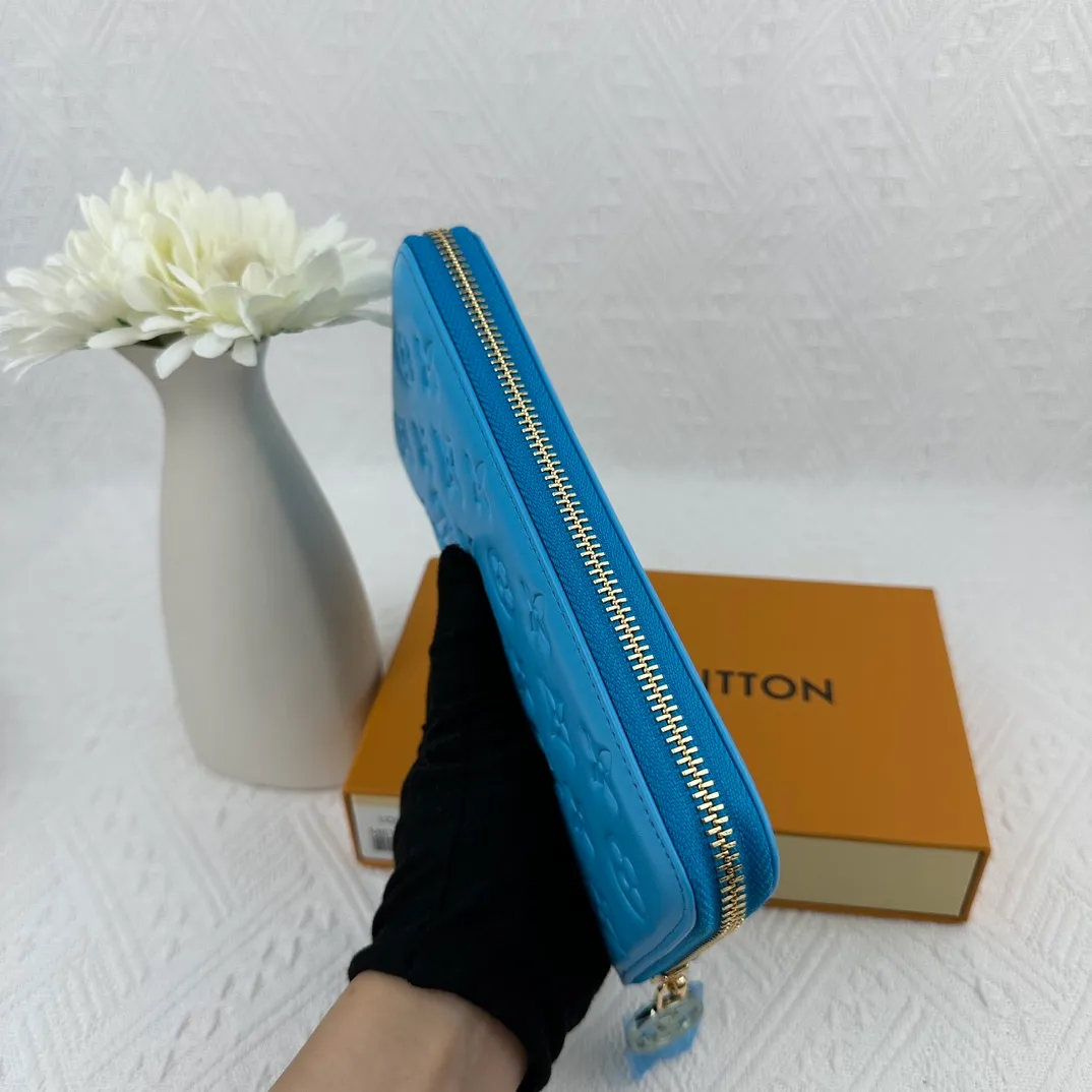 P130 M81511 blue Stitched with padded Monogram embossed lambskin, it complements the Coussin leather boutique collection. Beautifully designed with a gold-tone zipper embossed with the LV Circle signature pull, the interior of the all-in-one wallet is packed with practical features, including three large compartments, a coin compartment and 12 business card slots. Dimensions: 19.5 x 10.5 x 2.5 cm