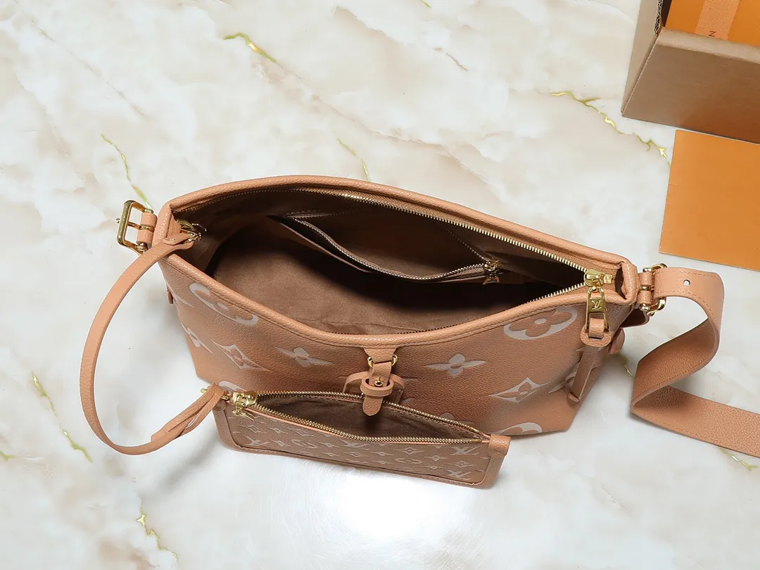 💰240💰Upgraded from the original M24141 M46288 M46293 M46277 M46298 M46203 CarryAll small handbag is made of Mono gram Empreinte embossed leather. It has a generous structure and a neat inner layer. The large inner bag adds functional elements. Comes with a Monogram embossed zipper clutch secured by a leather strap. A personal companion for urban life. Dimensions 29 x 24 x 12 cm (length x height x width)