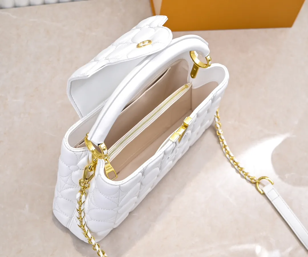 Upgraded version P440 M23999 White This Monogram embroidered flower emerges from the elegant quilting, giving the Capucines BB handbag the style of Louis Vuitton store decoration. Soft sheepskin creates a stable structure and trim, and the detachable shoulder strap allows for comfortable shoulder or cross-body wear. Dimensions: 33 x 19 x 9 cm