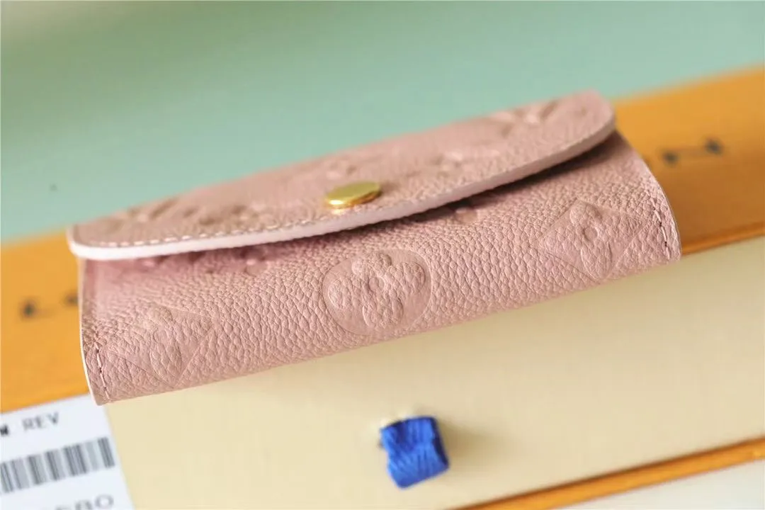 Factory price 280 [Top original order] M81455 pink first-layer cowhide👏👏This Rosalie coin purse is made of Monogram Empreinte embossed soft-grained cowhide. It opens with a round flip cover and has a compact configuration. It has a zippered coin pocket, a patch pocket and a card compartment inside. Louis Vuitton logo-engraved snaps secure the closure. Size: 11X8X2.5cm.