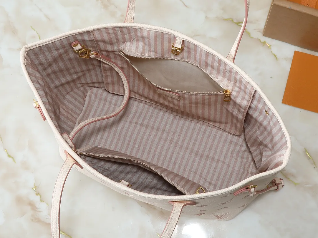 💰240💰Upgraded from the original M14285 M40995. This Neverfull MM medium handbag reinterprets the classic Monogram Empreinte leather with the same color aesthetic. The Neverfull is a roomy bag with side laces that can tighten up for a sleek allure or relax for a casual look. Inside there is a removable bag that is secured to the bag with a leather cord. Size: 32-29-17cm
