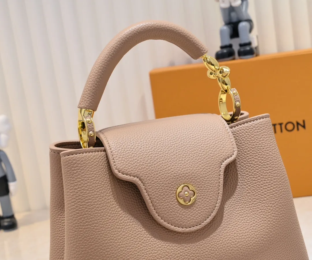 The upgraded version of the P460 M24698 Capucines BB handbag is made of Taurillon cow leather decorated with shiny metal parts, and the LV letters are written in 3D strokes. Metal Monogram flowers bloom quietly on the rolled leather handle, subtly proving the brand's exquisite craftsmanship. The detachable and adjustable leather shoulder strap allows for comfortable shoulder carrying. Detailed features 26.5 x17.5 x9 cm