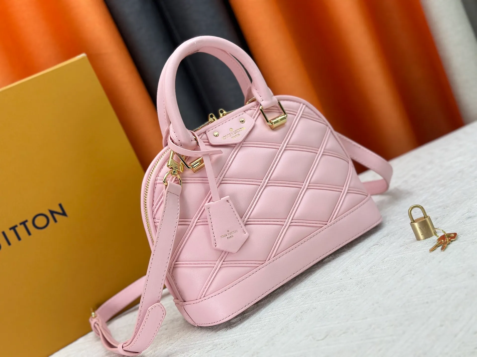 P360 M83048 M53152 This Nano Alma handbag is a pocket-sized version of Louis Vuitton's classic Alma handbag. It is made of soft lambskin with a Malletage quilting pattern, recalling the diamond inner panel of the brand's traditional hard luggage. The elegant handle, dazzling chain and detachable and adjustable leather shoulder strap enable a variety of carrying styles. Dimensions: 23.5x17.5x11.5cm