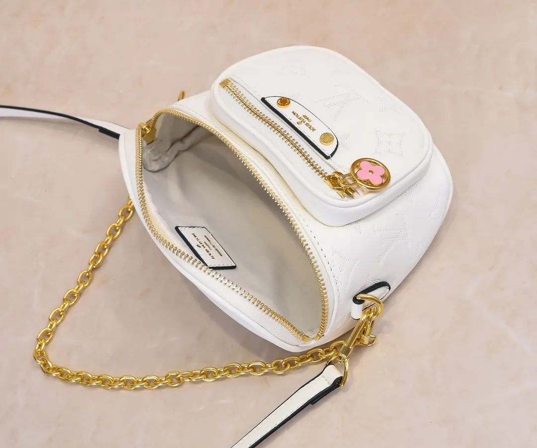 Batch 240💰Upgraded original M46917 M82335 M83275 M82208 M82347 This Mini Bumbag handbag comes from the LV Gradient series, and the Monogram embossing of Monogram Empreinte leather renders gradient midsummer colors. The on-trend construction features a zipped main compartment and a front pocket with a Louis Vuitton leather label. With the detachable chain and detachable and adjustable shoulder strap, it can be worn as a shoulder or cross-body bag. 17.0 x 12.0 x 9.5 cm (L x H x W) • Monogram Empreinte embossed soft-grained cowhide leather • Textile lining • Metal hardware • Zip closure • Zip front pocket • Shoulder strap: removable, adjustable • Half-length strap: 32.0 cm • Half-length strap adjustable to: 44.0 cm • Chain: Removable • Half-length chain: 20.0 cm