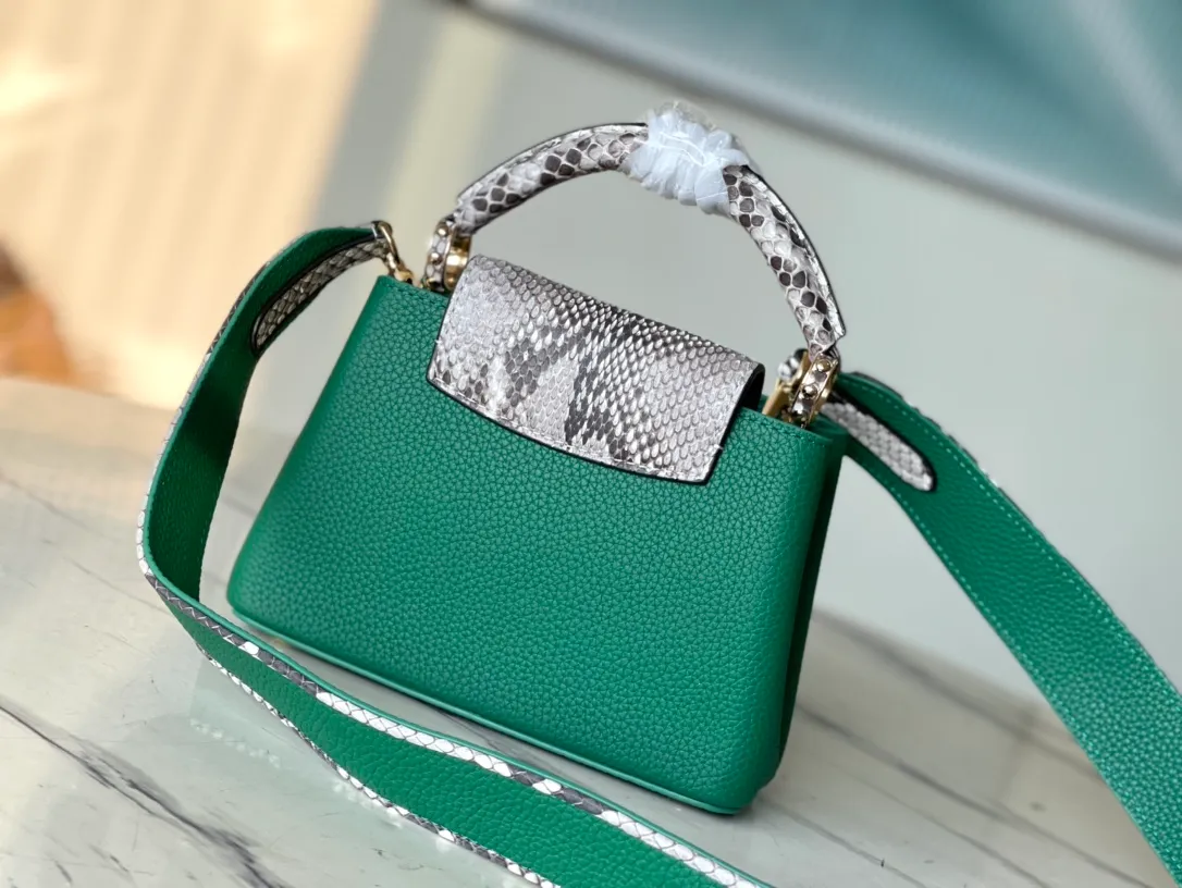 💰1860 (extra-grade original leather) N99387/M95509 green snake shoulder. This Capucines mini handbag is exquisitely constructed with full-grain Taurillon leather. It is equipped with a top handle, two flaps and a logo outlined in luster python leather, making it a gorgeous choice for both day and night. The detachable wide shoulder strap allows for an avant-garde look when worn on the shoulder or crossbody. Size: 21 *14 * 8cm