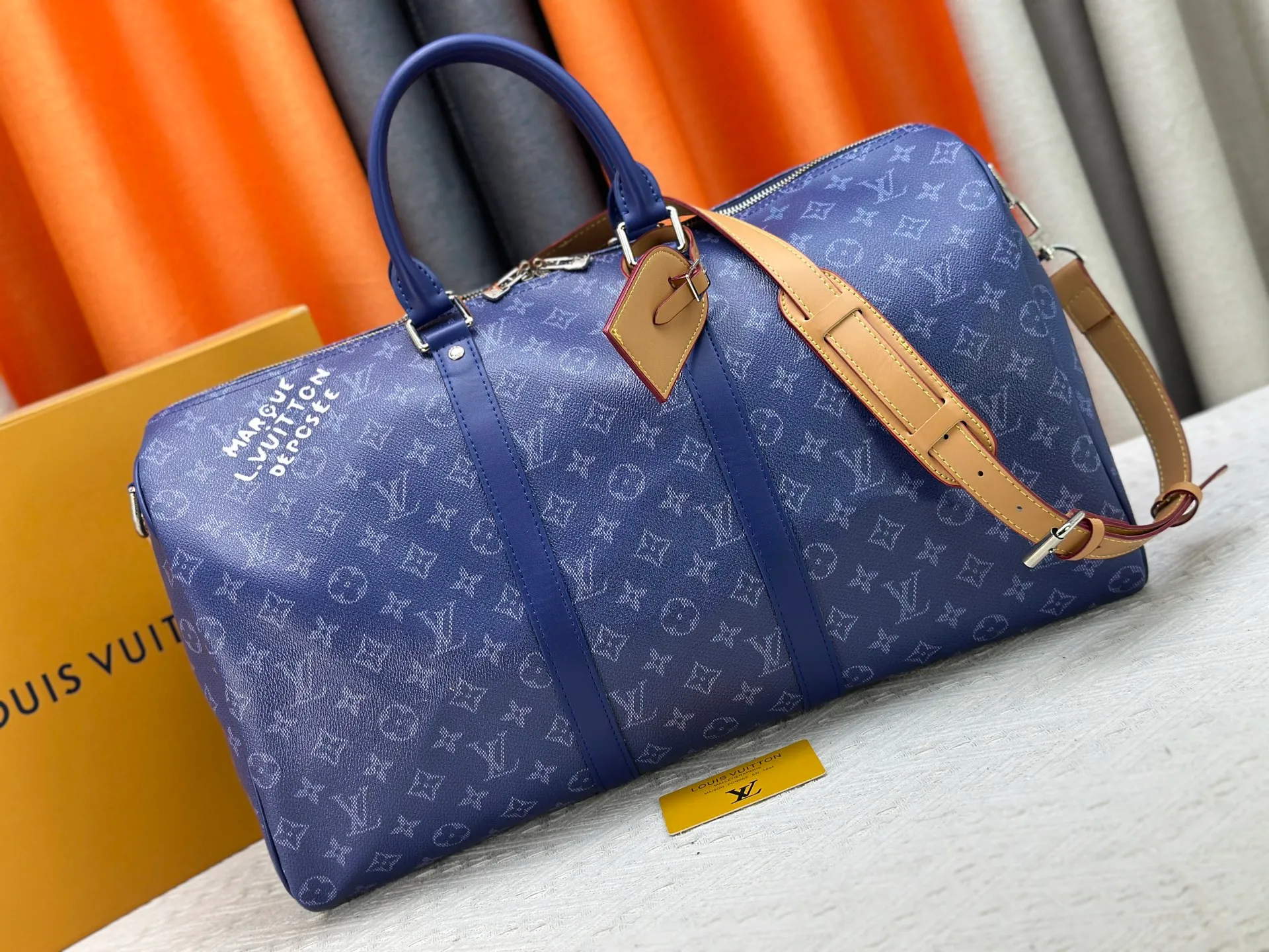 P340 Upgraded original M26864 M26865 M26866 This Keepall Bandoulière 50 travel bag is made of Monogram Heritage canvas dip-dyed in colorful colors, with cowhide trim, leather shoulder straps, removable leather nameplate and cotton lining. The Marque L.Vuitton Déposée logo pays homage to Louis Vuitton’s rich heritage.  29 x 23 x 50 cm (H x W x L) Monogram Heritage coated canvas Cow leather trim Textile lining Metal hardware Carry-on baggage dimensions Double zip closure Padlock Removable name tag Internal zip pocket Handles: Double handles