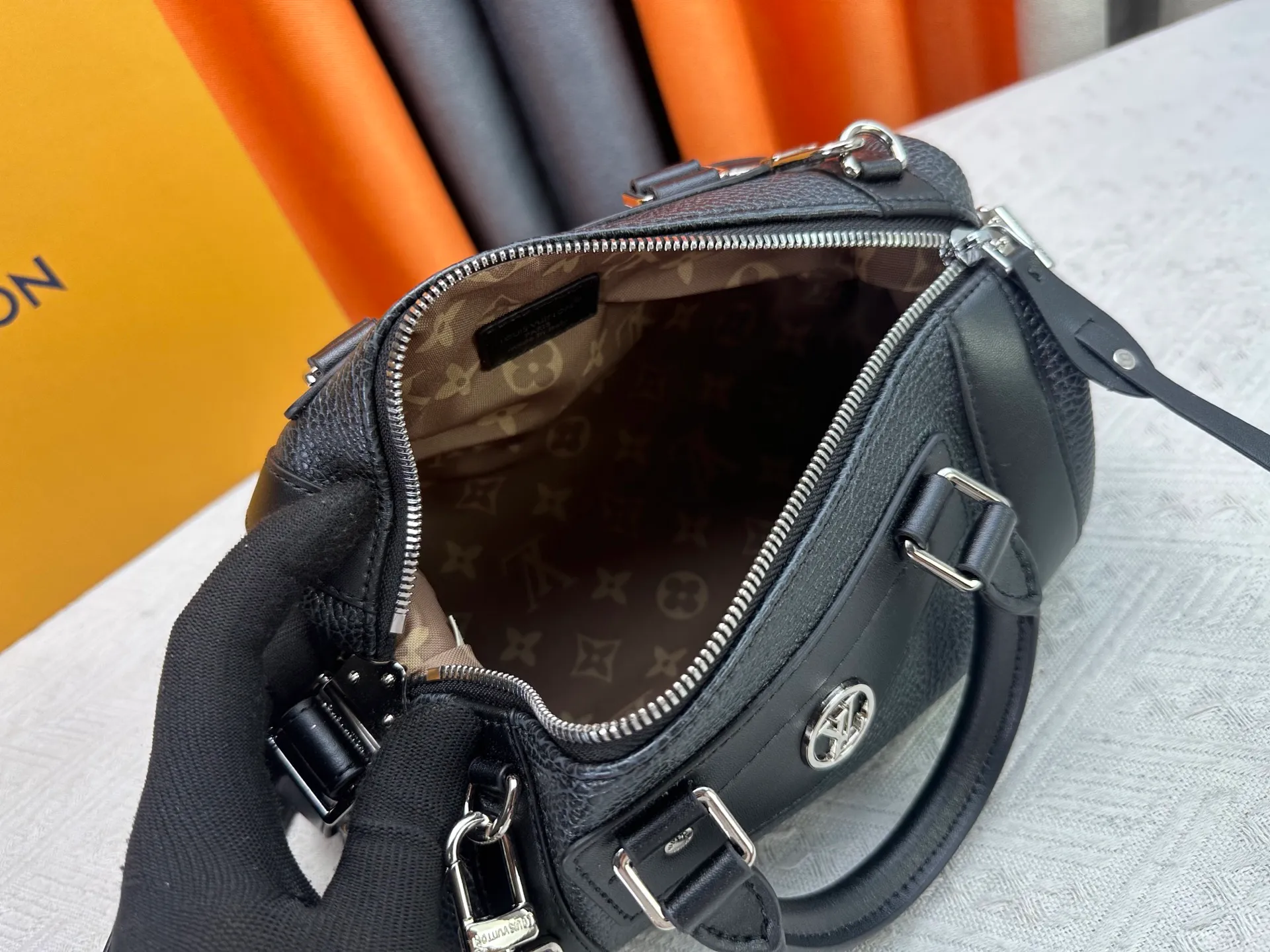 P300 small P320 medium P340 large M25557 M25561 M25561 M25566 Black M14623 mini M14514 small M14700 medium Dark gray M14702 medium Light gray M14721 small This Nano LV Rider handbag is from 2025 For the spring and summer series, pixelated grained sheep leather is blended with smooth cow leather elements, and the LV Circle logo is highlighted with elegant patches. The foldable configuration makes it easy to store in a suitcase, and the modern design adds a rock-n-roll edge to any look.  Mini 10 x 10 x 23 cm Small 12 × 12 × 30 cm Medium 15 × 15 × 38 cm (H x W x L) Sheep leather Cow leather trim Textile lining Metal hardware Zipper closure Side slip straps Internal pocket Holds a 6.7-inch smartphone, Romy card holder and lipstick Shoulder strap: removable, adjustable Strap half-length: 30.0 cm Bag strap half length adjustable to: 45.0 cm Handle: double handle