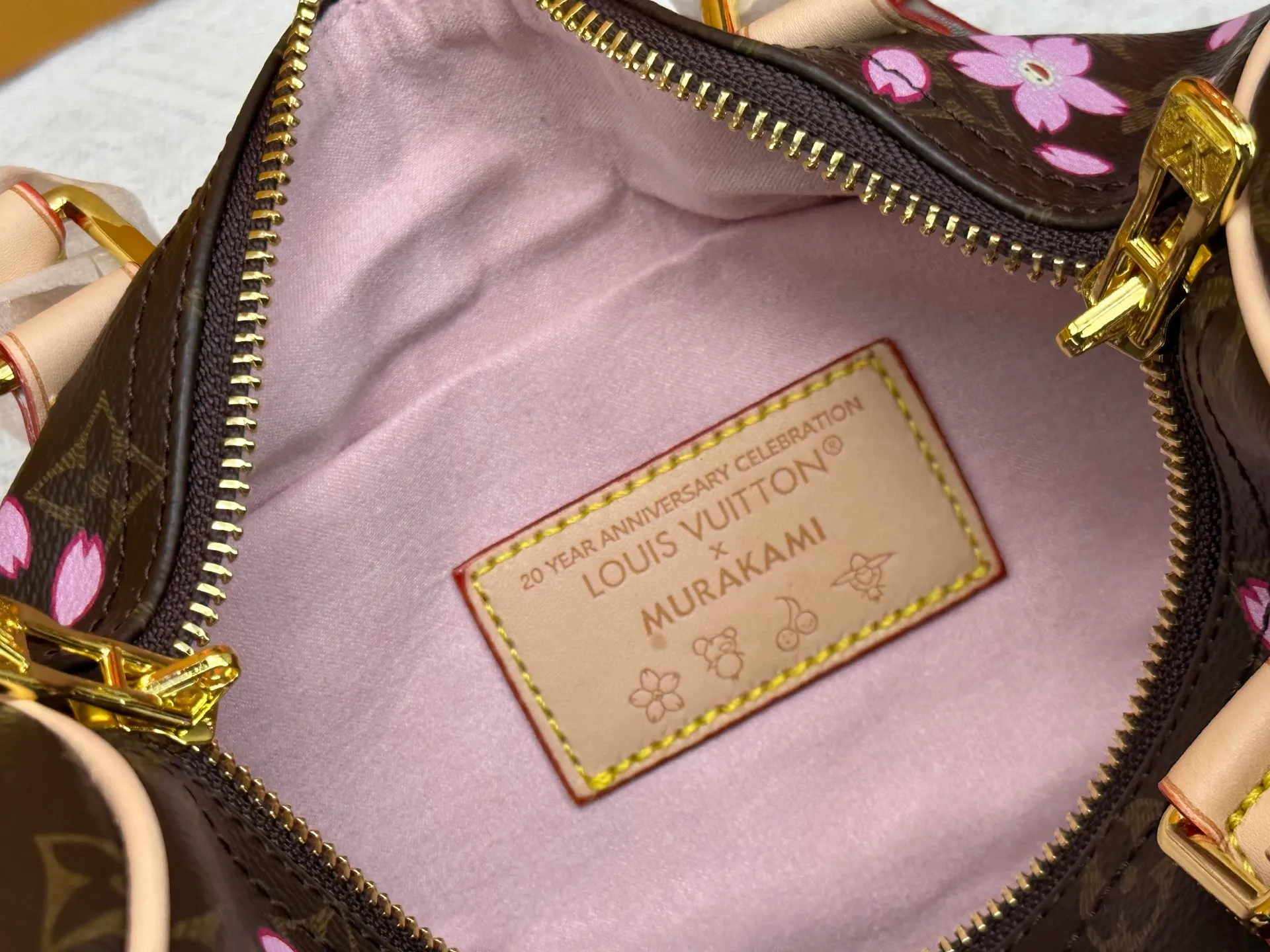 P260 M14174 This Speedy Bandoulière 25 handbag is from the Louis Vuitton x Takashi Murakami replica series. It incorporates the brand's classic Monogram coating into Takashi Murakami's vivid Cherry Blossom pattern, and then continues the same element into the removable bag decoration. Cow leather constructed Toron handles and removable leather shoulder strap, dual zippers and padlock keep personal belongings safe and secure.  19 x 15 x 25 cm (H x W x L) Cherry Blossom Monogram coated canvas Cow leather trim Removable Cherry Blossom trim Textile lining Metal hardware Double zip closure Internal zip pocket Padlock Holds a 6.7" smartphone, Victorine short wallet, headphones and keys Shoulder strap: removable, not adjustable Half-length strap: 44.0 cm Handles: Double handles