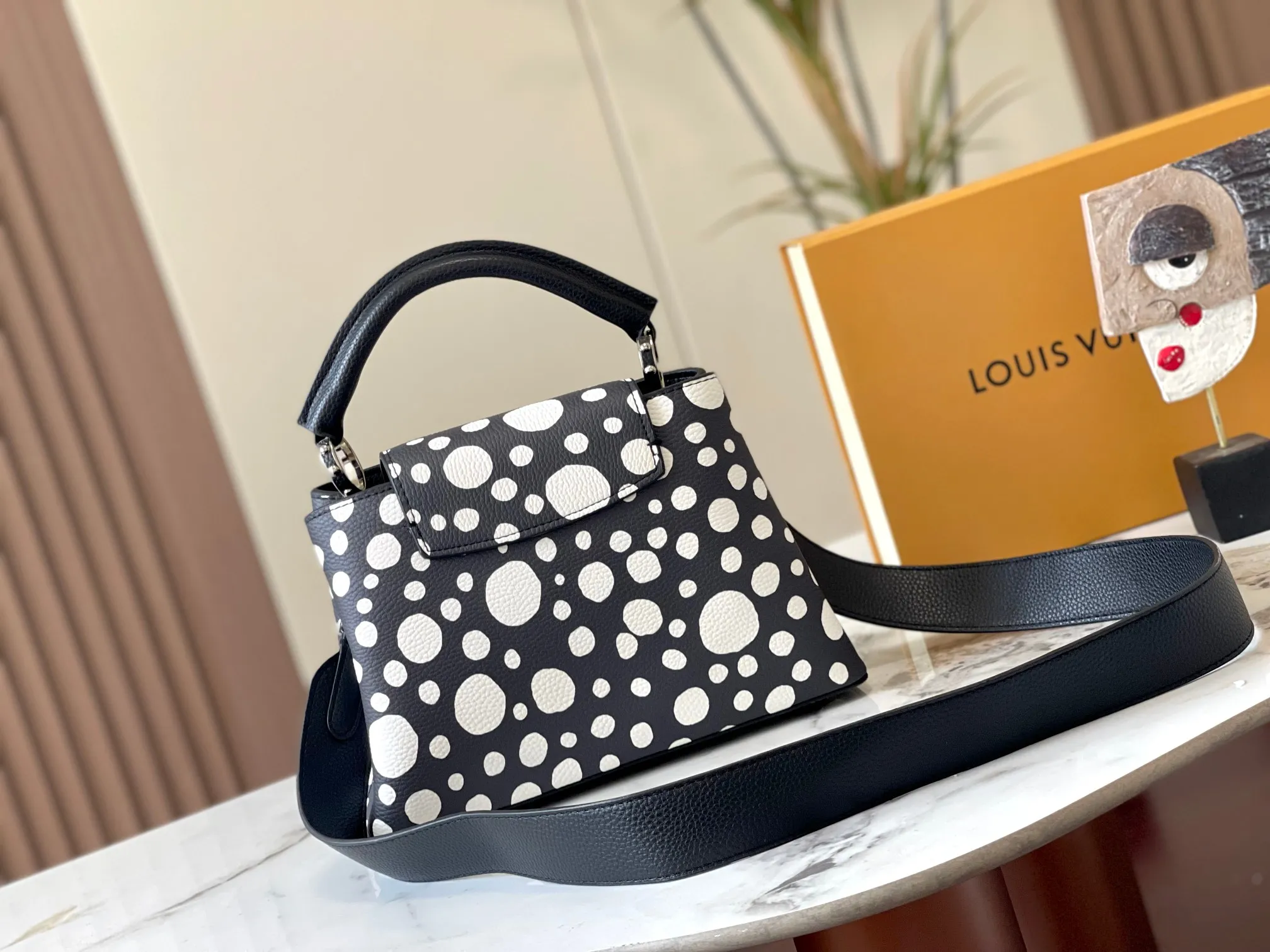 Upgraded version P440 M21663 This LV x YK Capucines small handbag comes from the Louis Vuitton x Yayoi Kusama collaboration series. The renowned Japanese artist has been obsessed with polka dots as a symbol of infinity since childhood, and finds a dazzling expression in supple Taurillon leather decorated with 3D hand-painted polka dot prints. Detailed features 27 x 18 x 9 cm (length x height x width)