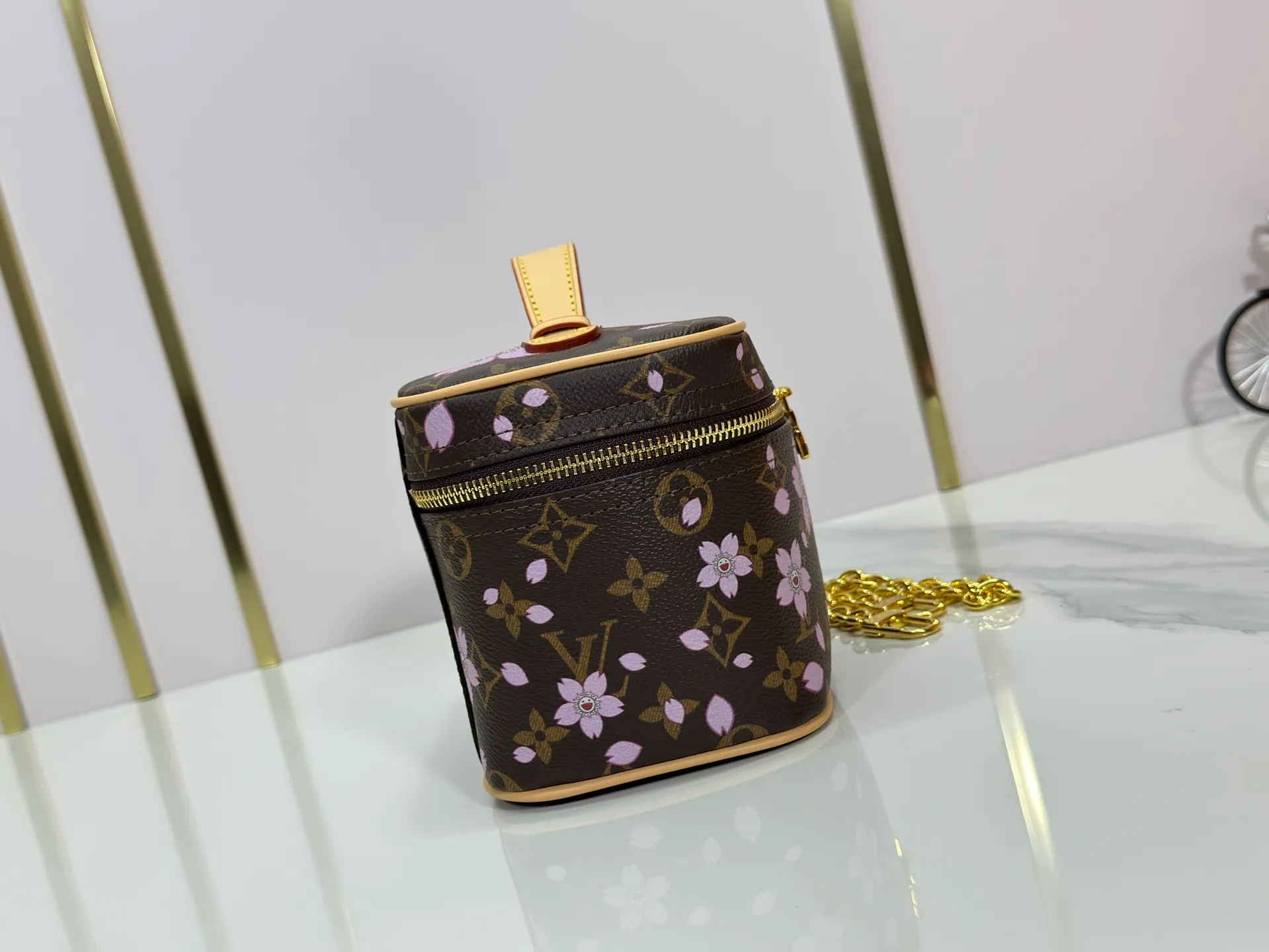 P240 Upgraded original M14181 M44495 This Nice mini cosmetic bag is made of Monogram coated canvas. The box-shaped outline is condensed with rounded strokes. The Cherry Blossom pattern releases the joyful atmosphere of the Louis Vuitton