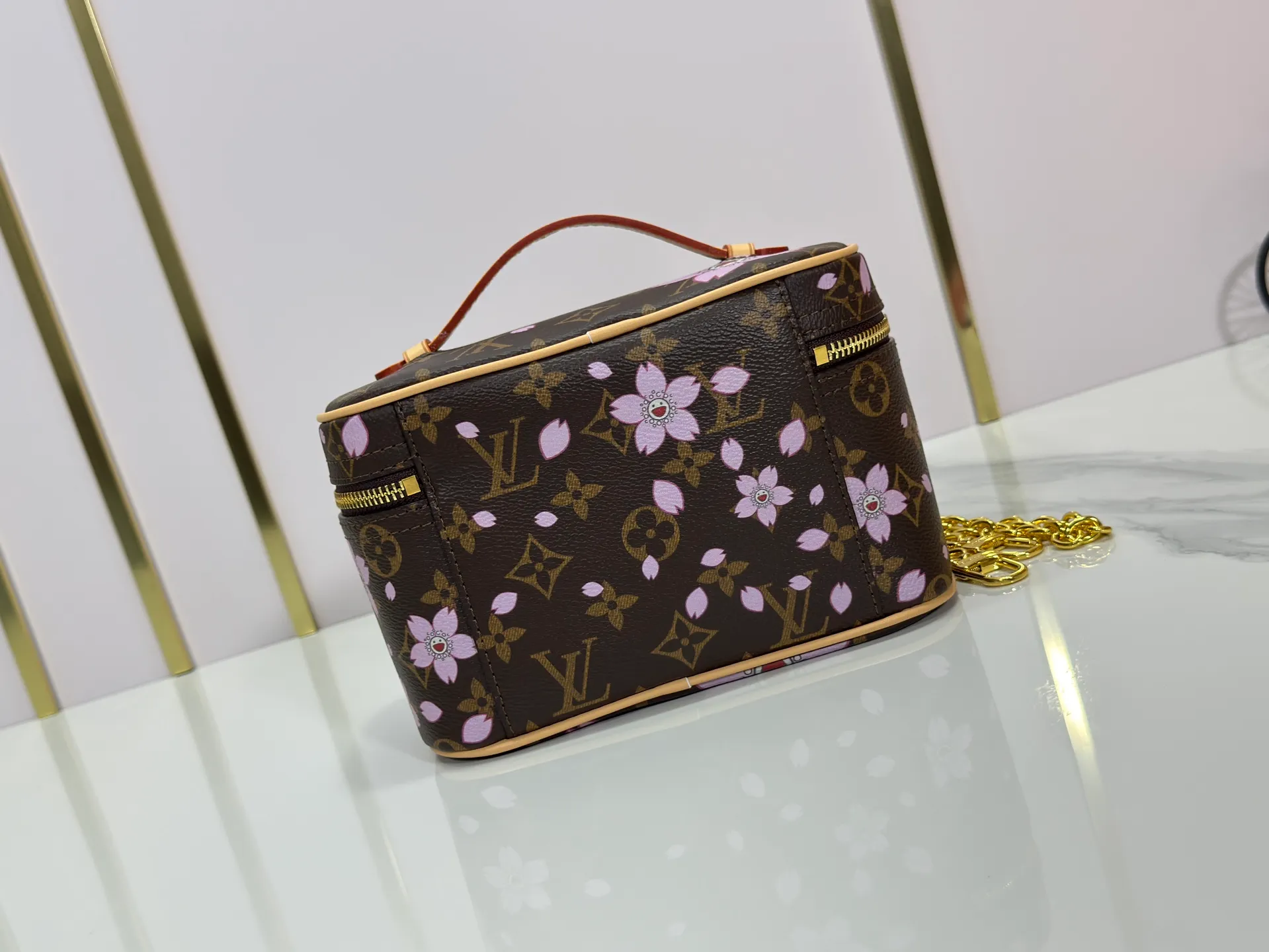 P240 Upgraded original M14181 M44495 This Nice mini cosmetic bag is made of Monogram coated canvas. The box-shaped outline is condensed with rounded strokes. The Cherry Blossom pattern releases the joyful atmosphere of the Louis Vuitton