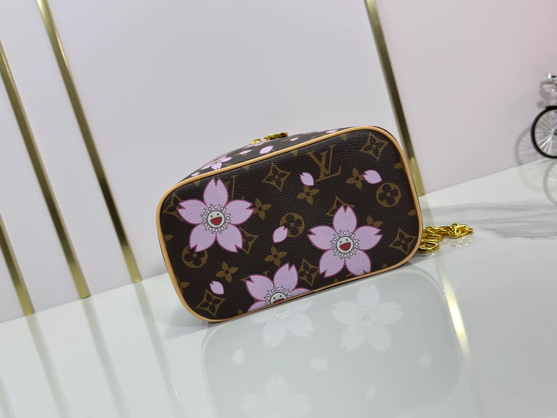 P240 Upgraded original M14181 M44495 This Nice mini cosmetic bag is made of Monogram coated canvas. The box-shaped outline is condensed with rounded strokes. The Cherry Blossom pattern releases the joyful atmosphere of the Louis Vuitton