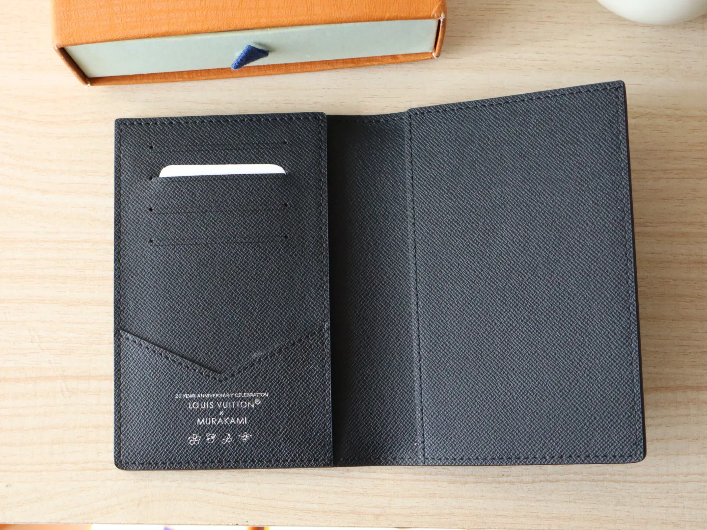 13414 Tricolor Passport🌟 P86 Top Original LV x TM Passport Case M13414 Black Color (White Color Black Color-Takashi Murakami) This passport cover is lined with coated canvas and cow leather, and the Monogram pattern is updated with the rainbow tones of artist Takashi Murakami, which expresses the smart style of the Louis Vuitton x Murakami collaboration series. Card compartments and multiple pockets add functional details. Dimensions: 14 x 2.5 x 10 cm
