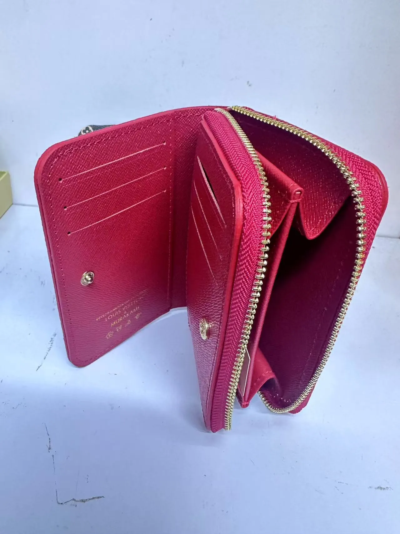 P150 M83689 This Cléa wallet is made of Monogram Empreinte soft grained cowhide, embellished with Louis Vuitton's iconic Monogram embossed pattern. It has a stylish design, is compact yet spacious, and is equipped with an external patch pocket, zipper coin pocket, banknote compartment and six credit card slots.