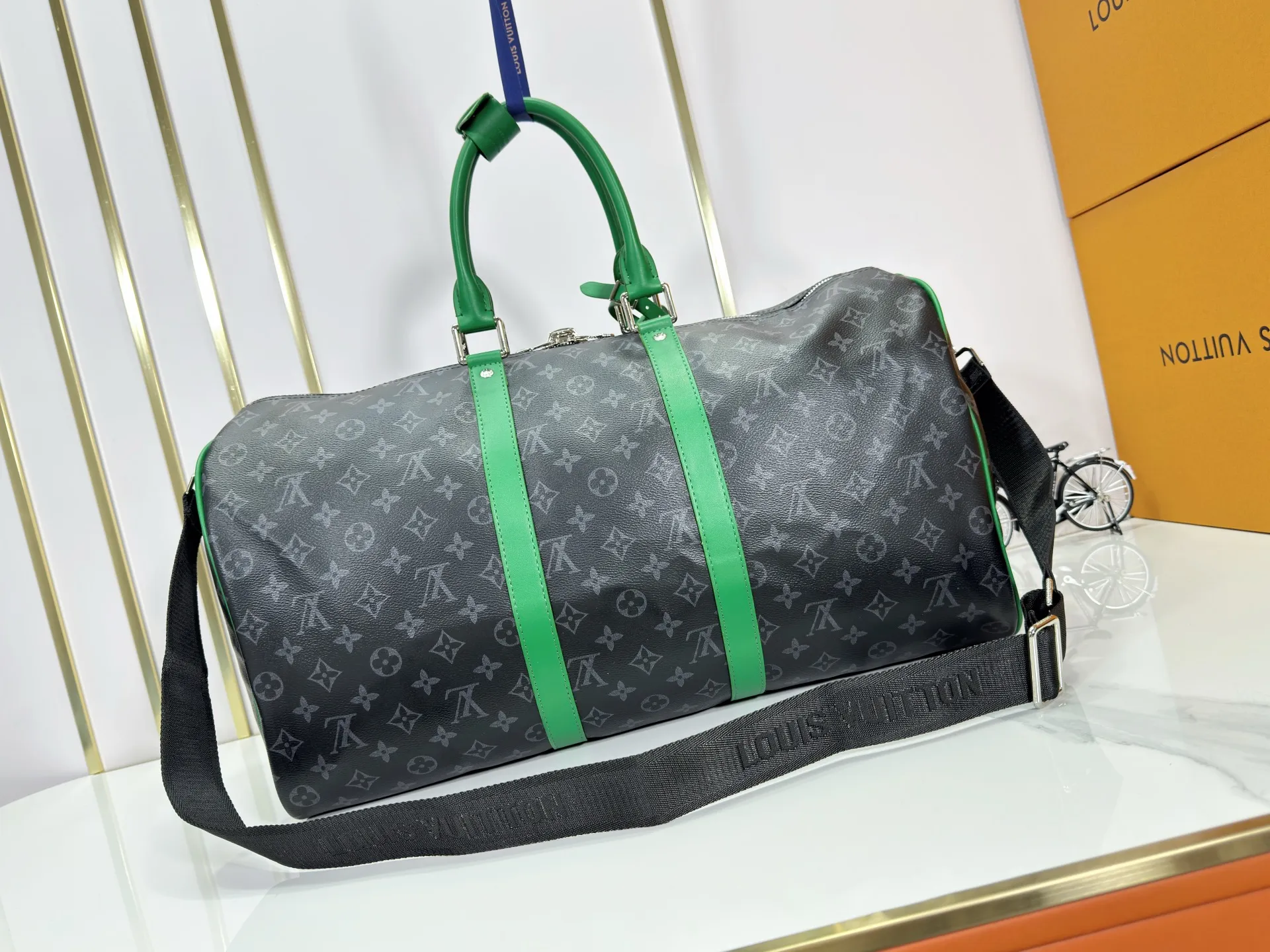 P340 M26434 M41416 Upgraded from the original version, this Keepall Bandoulière 50 travel bag is made of Monogram Eclipse canvas, with bright side straps and top handles to inject a dynamic feel. Compact construction with fabric lining and zippered pockets for on-the-go convenience. The removable and adjustable shoulder strap allows for shoulder or cross-body wear. 29 x 23 x 50 cm (height x width x length)