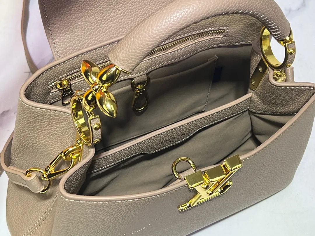 Batch 380💰Upgraded original M23943 M23944 M23945 M24698 M24989 This Capucines mini handbag incorporates exquisite Monogram flowers on the handle, presenting the three-dimensional look of the LV logo with delicate brushstrokes, injecting dazzling luster into the soft design. Full-grain Taurillon leather is designed to fit a smartphone, short wallet and other small essentials. Dimensions: Small 21.0 x 14.0 x 8.0 cm (L x H x W) Large 27x 17.5 x 9.0 cm (L x H x W)