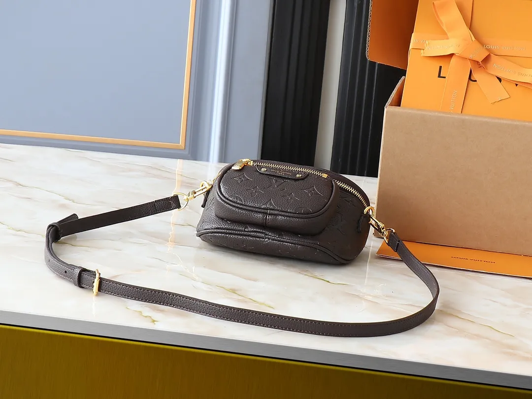 💰200💰Upgraded from the original M46917 M82335 M83275 M82208 M82347 This Mini Bumbag handbag comes from the LV Gradient series and uses the Monogram embossing of Monogram Empreinte leather to render gradient midsummer colors. The on-trend construction features a zipped main compartment and a front pocket with a Louis Vuitton leather label. With the detachable chain and detachable and adjustable shoulder strap, it can be worn as a shoulder or cross-body bag. 17.0 x 12.0 x 9.5 cm (L x H x W) • Monogram Empreinte embossed soft-grained cowhide leather • Textile lining • Metal hardware • Zip closure • Zip front pocket • Shoulder strap: removable, adjustable • Half-length strap: 32.0 cm • Half-length strap adjustable to: 44.0 cm • Chain: Removable • Half-length chain: 20.0 cm